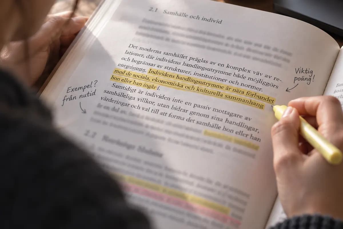 En hand stryker över rader i en kursbok med överstrykningspenna.